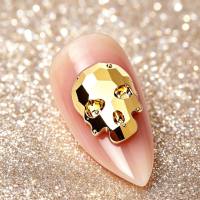 gold nail skull charm
